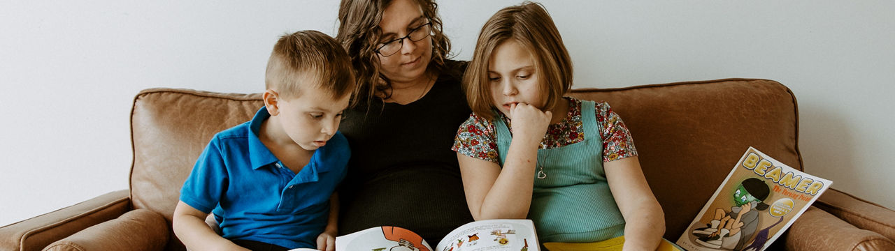 Deneige and her children read Beamer Book from Children's Program