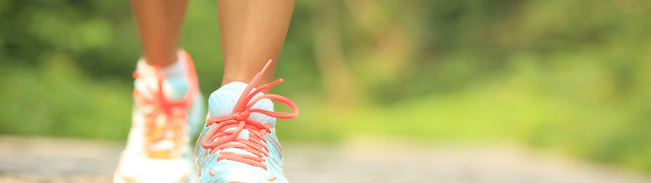 fitness woman hiker feet hiking on stone trail