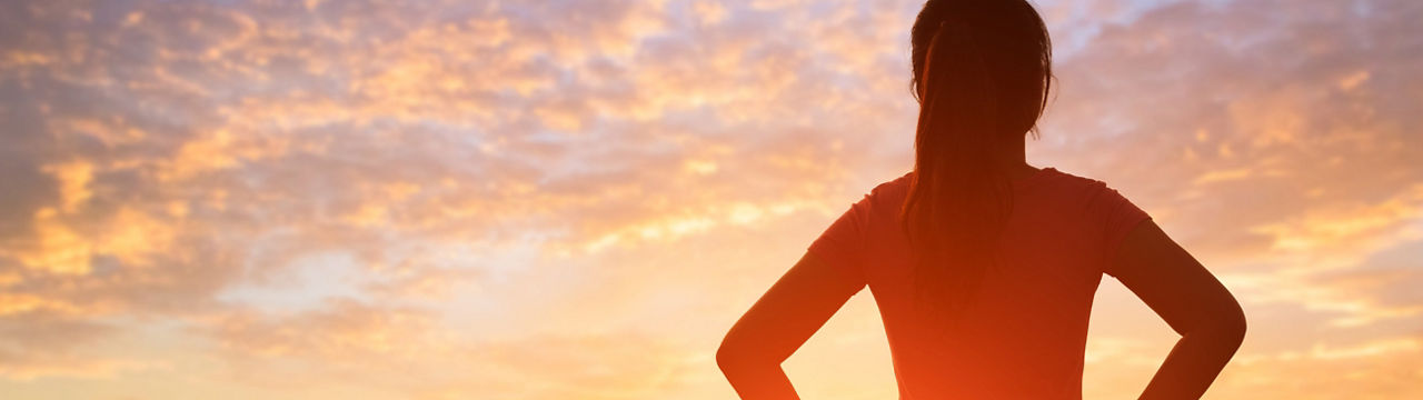 silhouette of sport woman look somewhere with sunlight