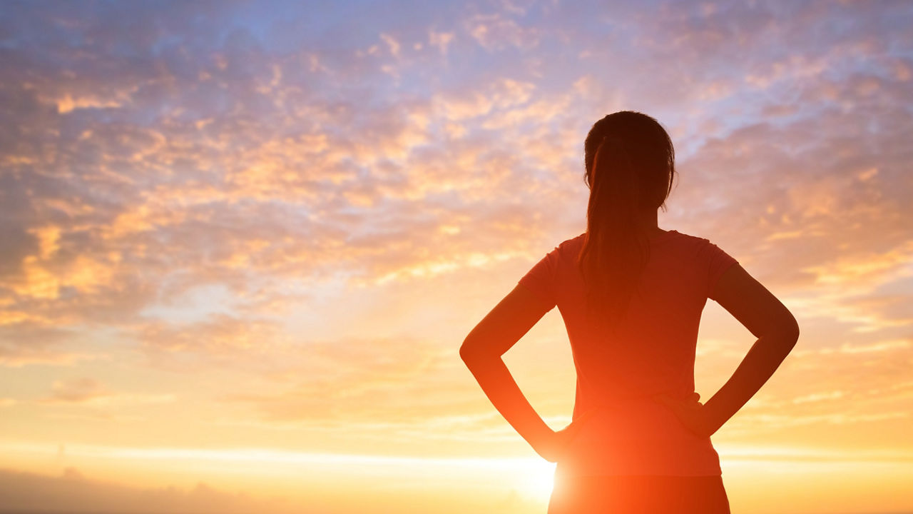 silhouette of sport woman look somewhere with sunlight