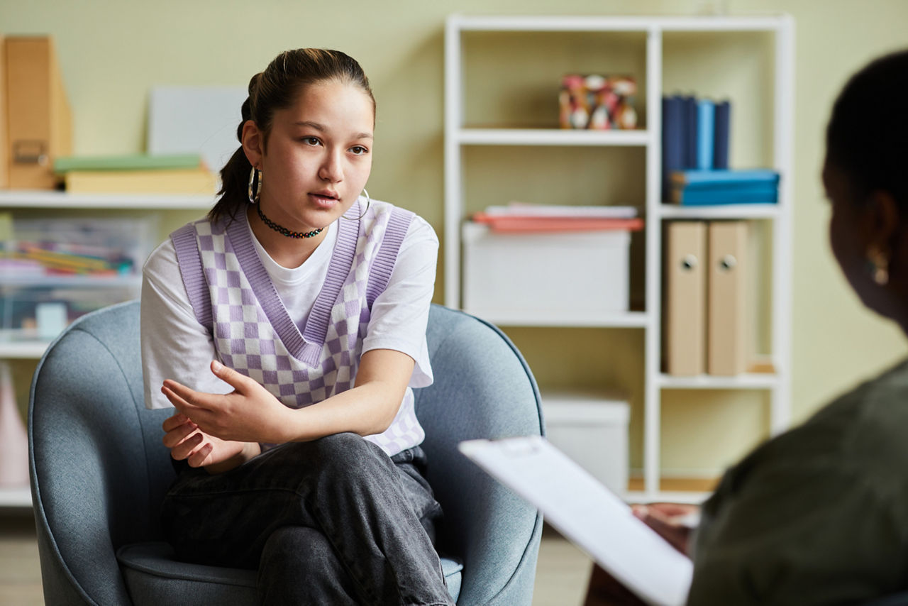 Young girl sitting in a therapy room