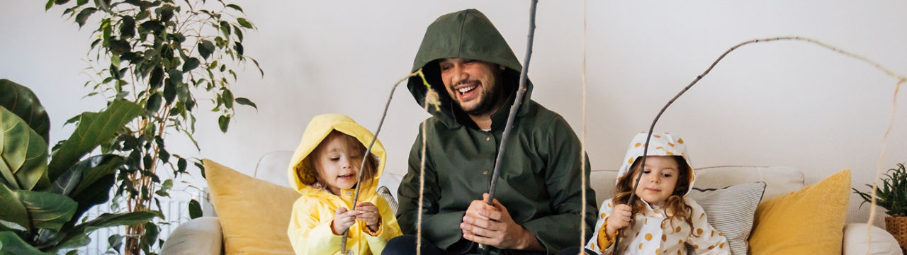 Happy child and young father with inflatable ring and drawing tropical fishes around him