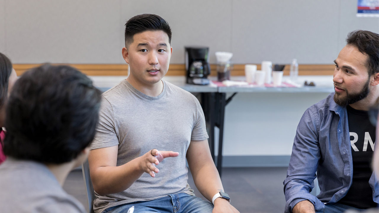 Adult male veteran shares his story, the unrecognizable therapist takes notes