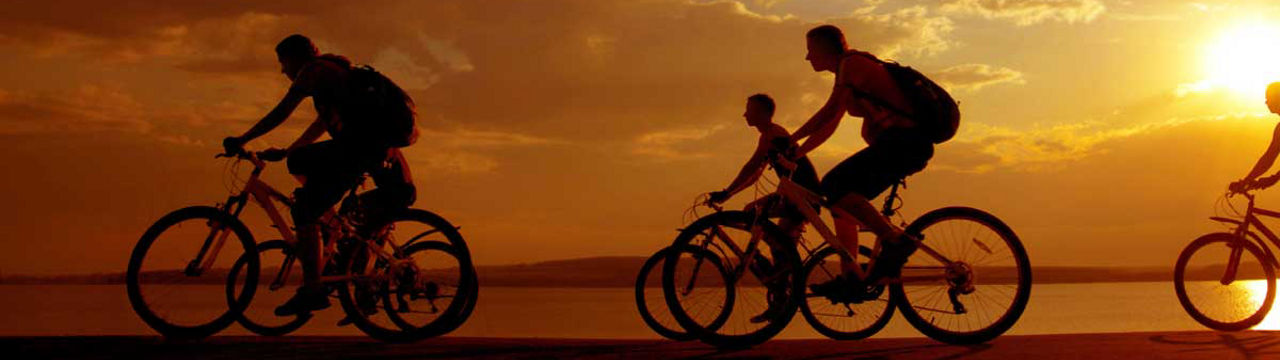 Family biking at sunset