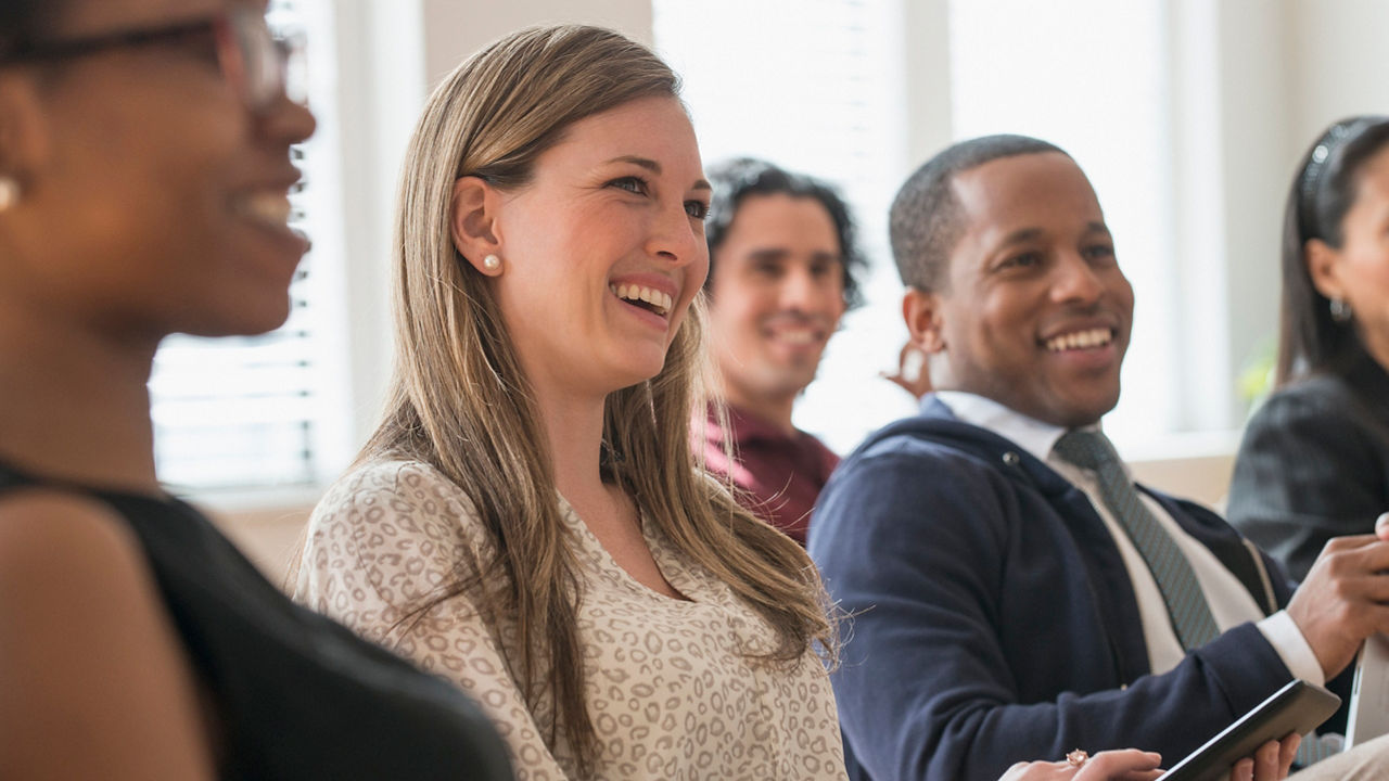 Business people laughing in presentation in office