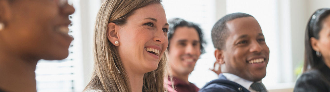 Business people laughing in presentation in office