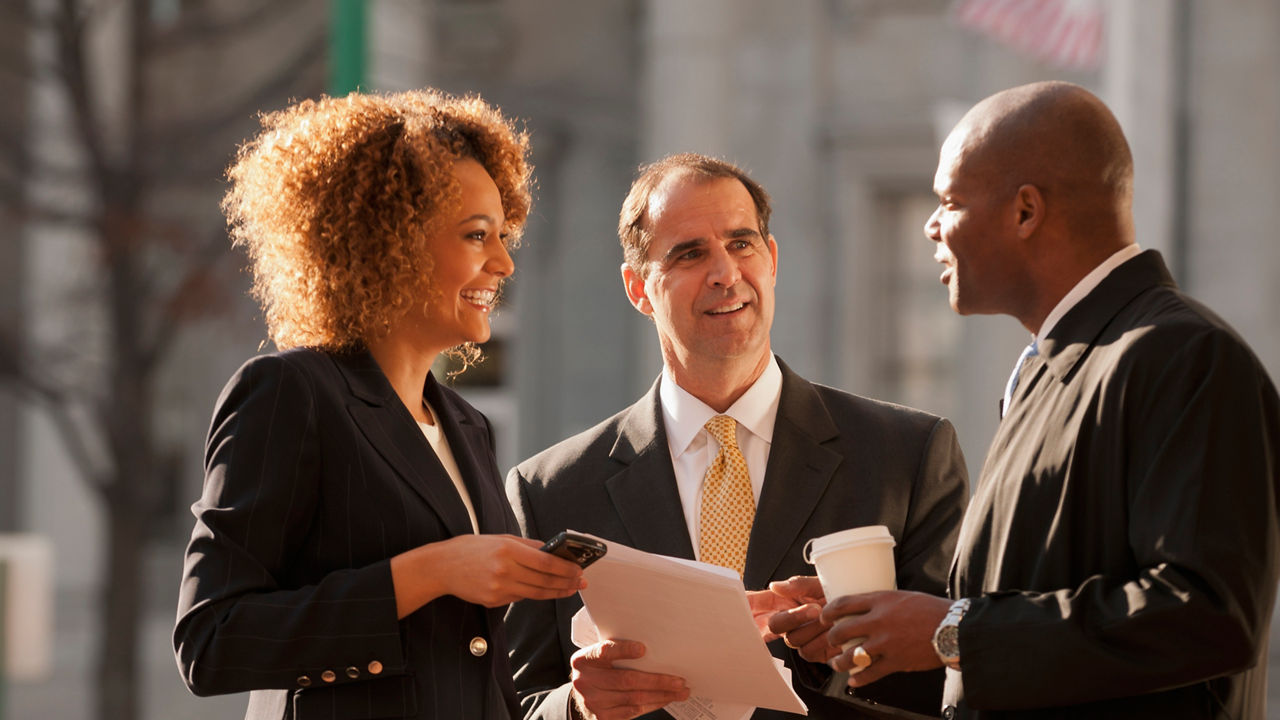 Business people talking together outdoors , 20-24 years,45-49 years,50-54 years,african-american ethnicity,business,businessman,businesswoman,caucasian,cell phone,city life,co-worker,coffee,coffee cup,color image,confidence,connection,convenience,cooperation,day,disposable cup,focus on foreground,food and drink,happy,holding,man,mature adult,mature men,mixed race person,mobility,multi-ethnic group,multicultural,multiculturalism,norfolk,paperwork,partner,people,reviewing,showing,smiling,standing,suit,takeout food,talking,three people,three quarter length,together,united states,urban,vertical,working together,young adult,young women, iphone, african american, female, woman, women, man, male, men, work, professional, business, outside, outdoors, talk, talking, chat, meeting, coffee, sunshine, coffee cup, latte