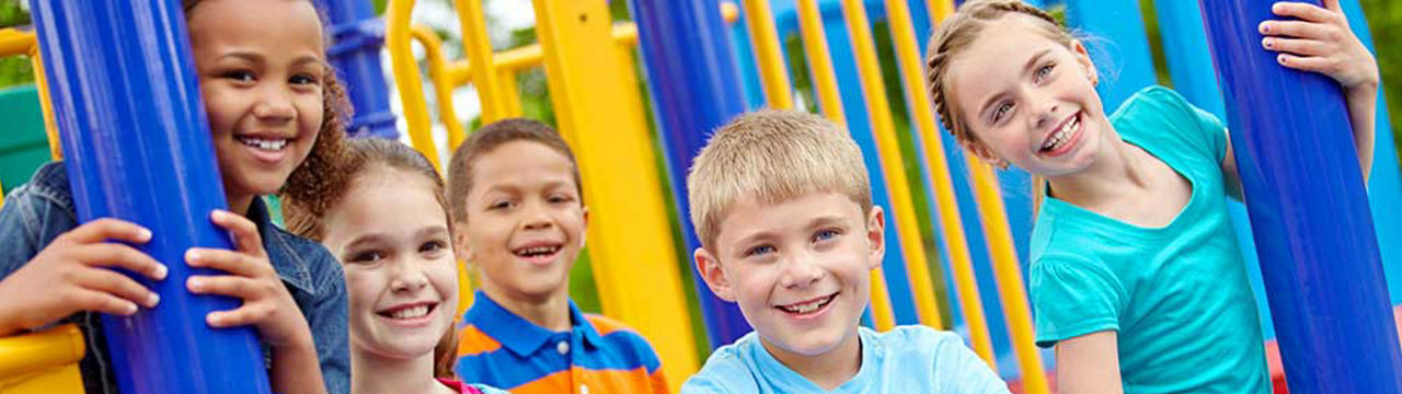 Children on playground smiling