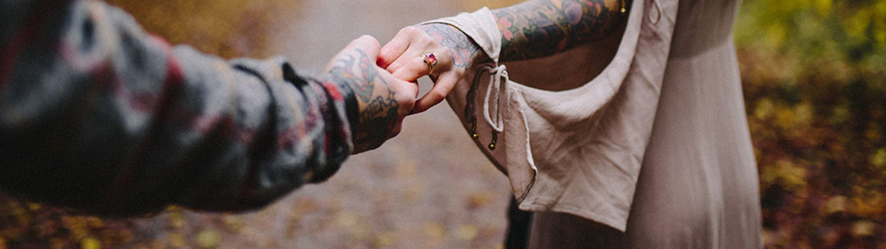 Couple With Tatoo Joining Hands