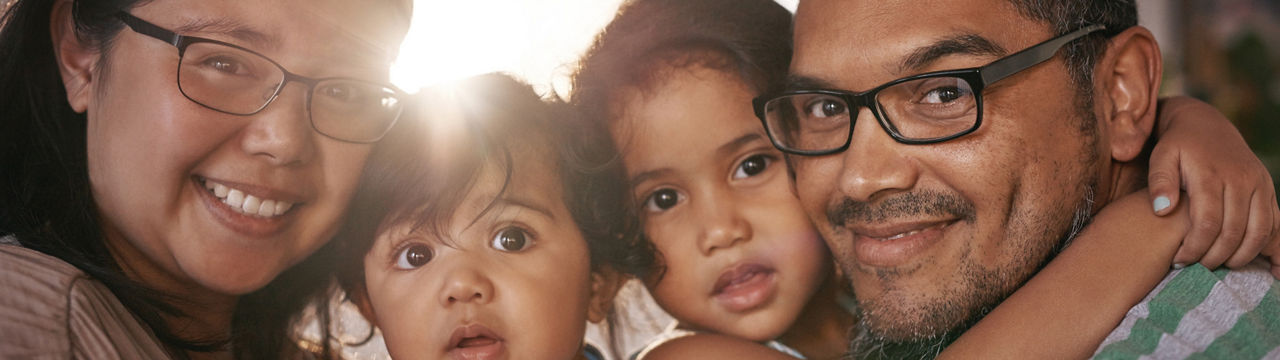 Biracial family sitting in living room