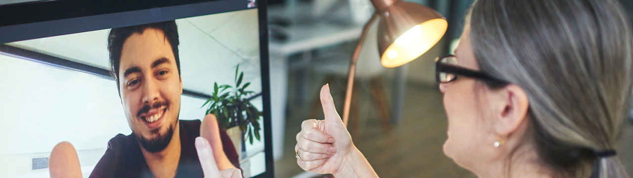 ID 332, Shot of a young man showing thumbs up during an online counseling session with a psychologist