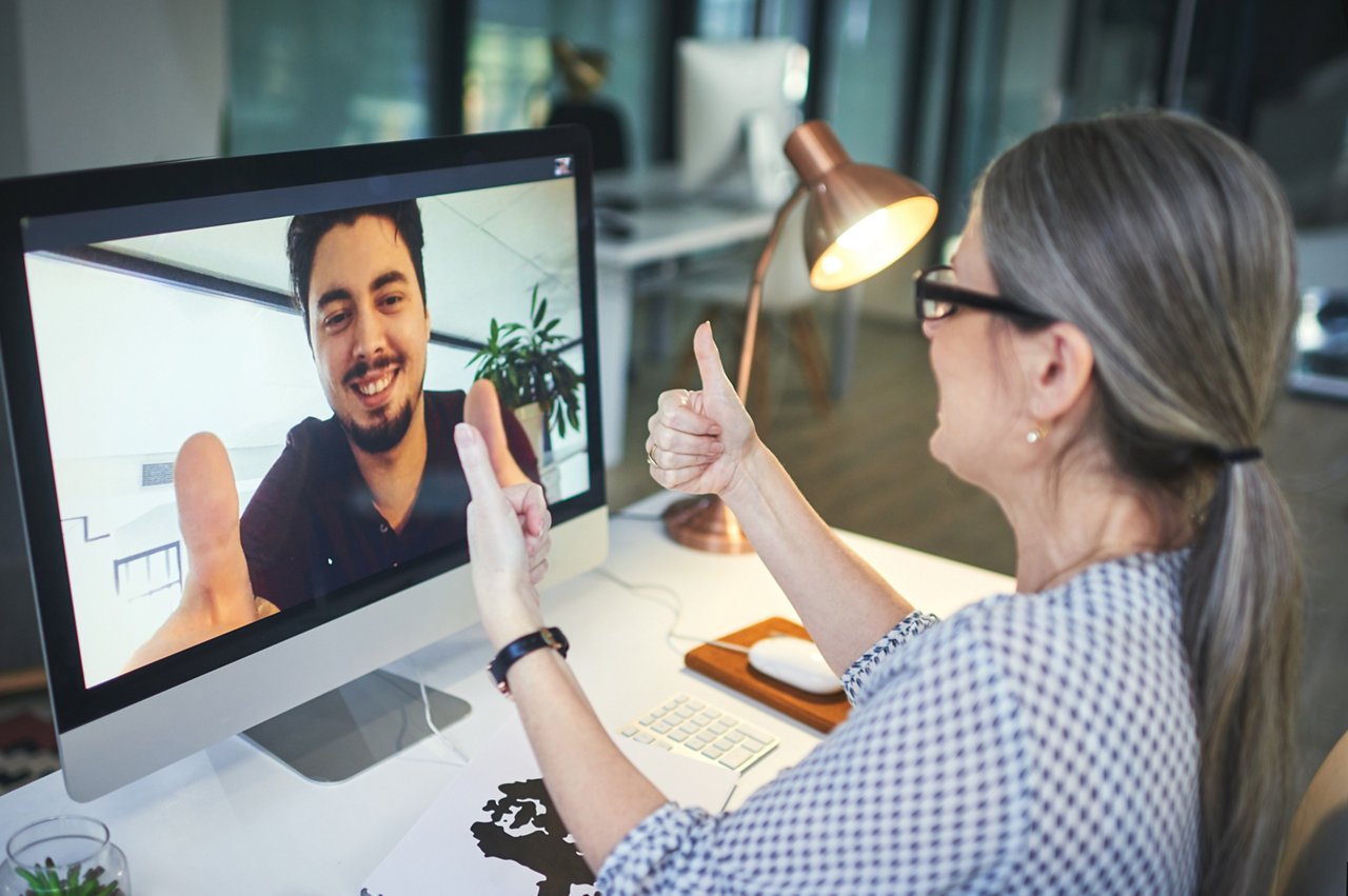 Shot of a young man showing thumbs up during an online meeting