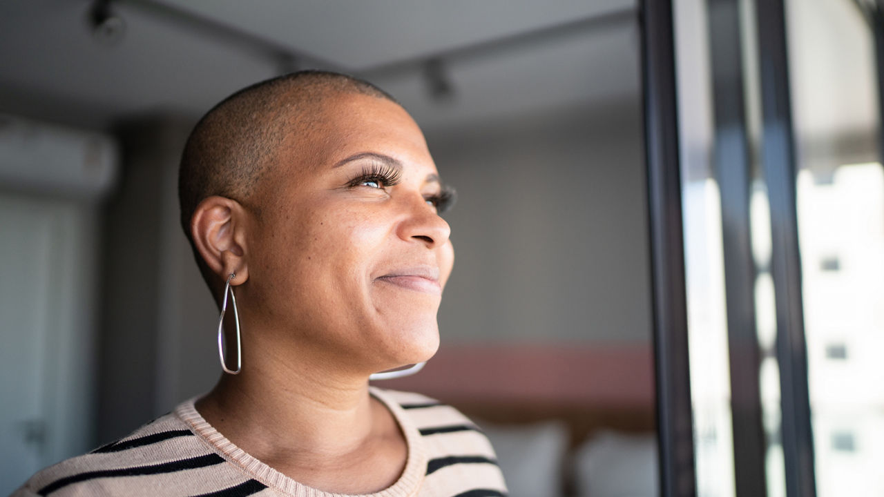 Mature woman contemplating at home