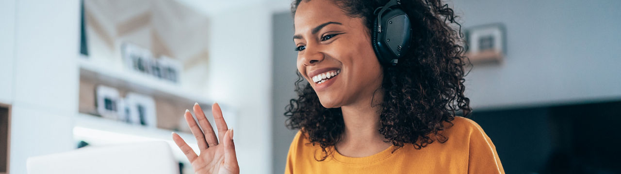 Young modern woman having video conference at home