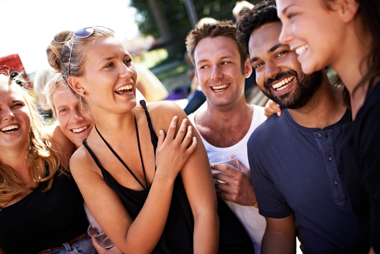 Group of smiling friends hanging out and having fun together