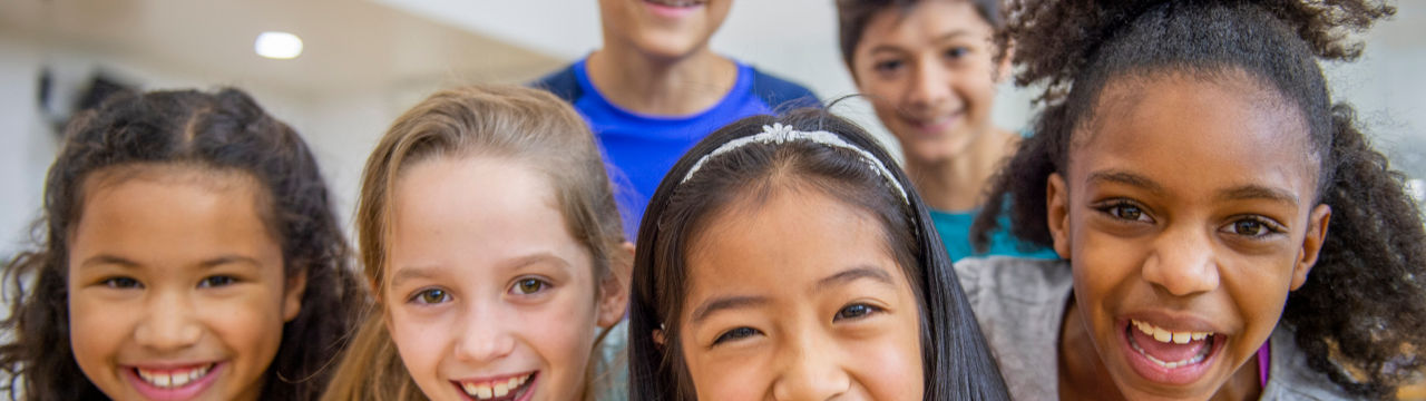 Diverse group of elementary aged kids in fitness class