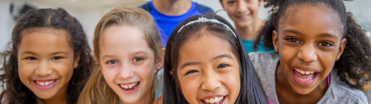 Diverse group of elementary aged kids in fitness class