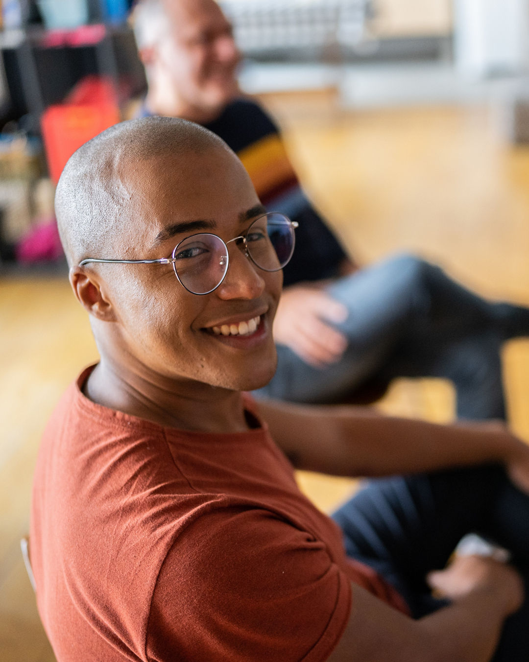 Portrait of a young man in group therapy at a coworking