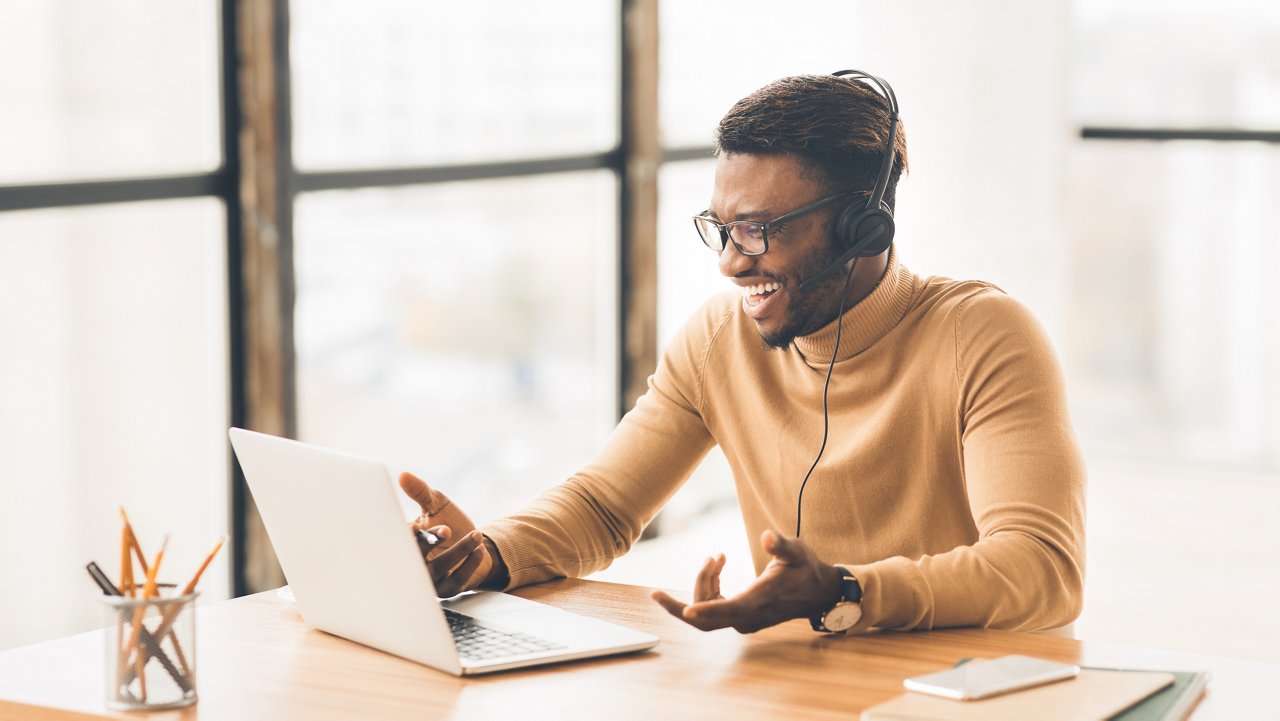 Family Video Call. Happy black student in headset chatting with relatives and friends, 