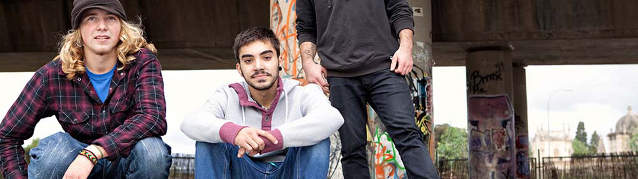 Males with skateboards bridge