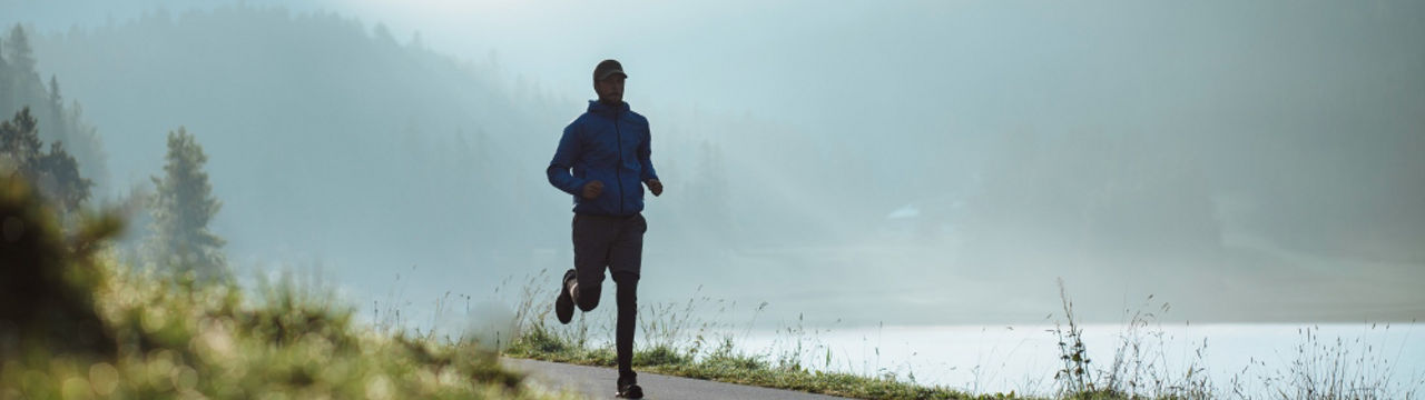 Man running near lake 1000x400