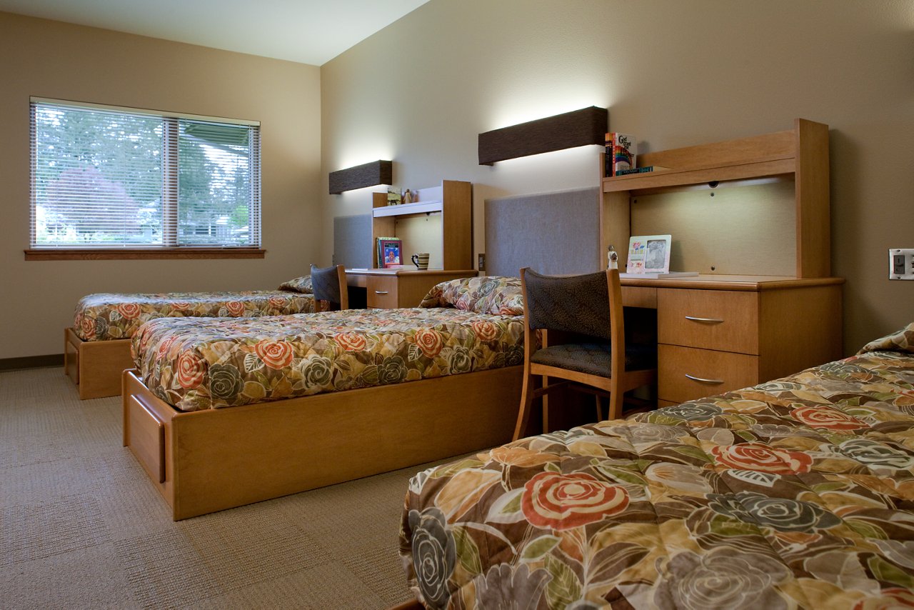Inside a shared bedroom with comfortable beds and personal desks
