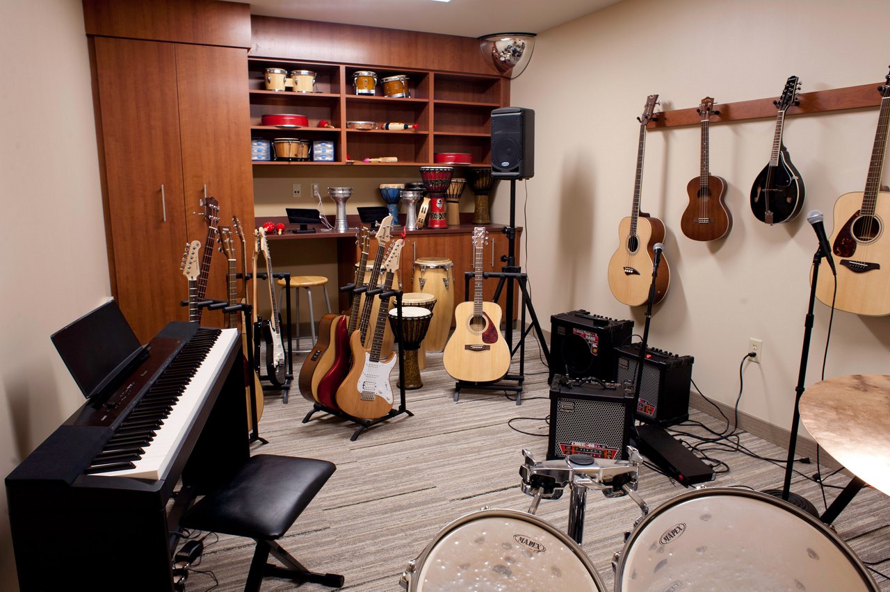 Inside the music room with guitars, piano, drums and other instruments