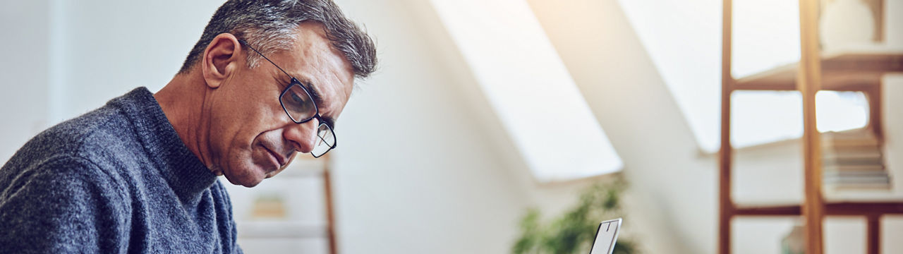 Shot of a senior man using a laptop at home