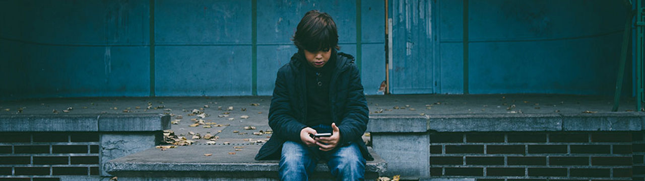 Young male sitting on cell phone