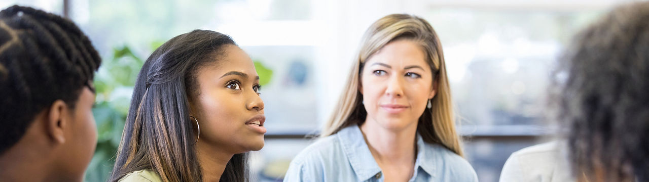 As the teen girl gestures and expresses strong emotion, everybody looks to her.