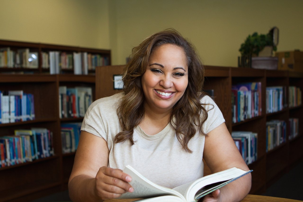 Woman reading a book in the library