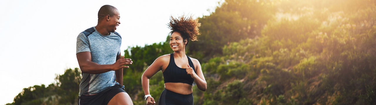 Shot of a young couple out running together