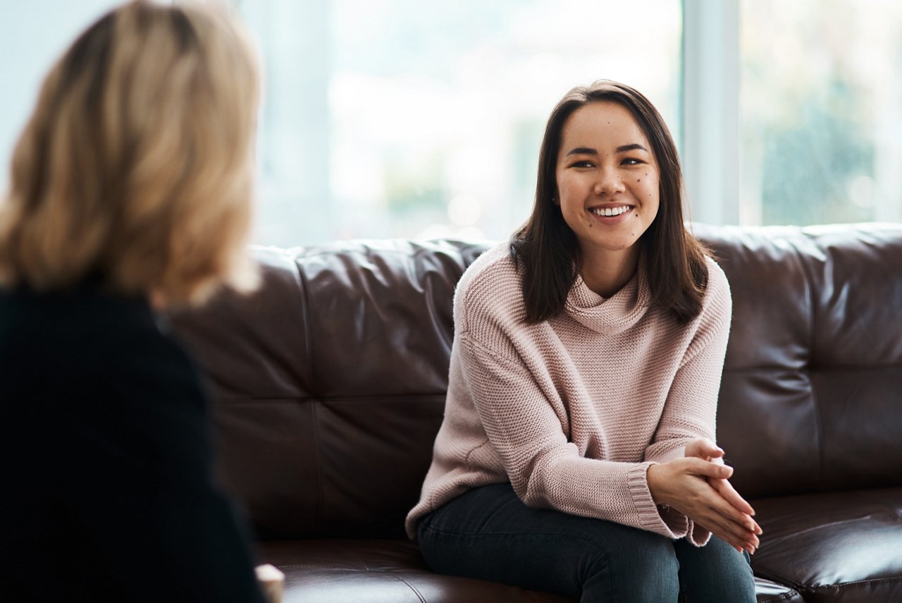 Shot of a young woman having a therapeutic session with a psychologist