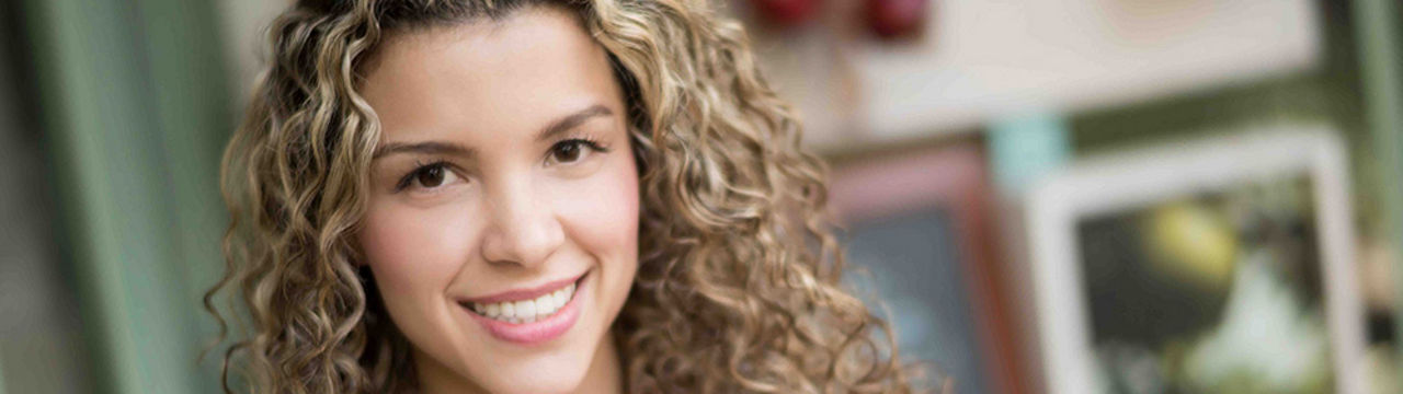 Smiling young female with curly hair