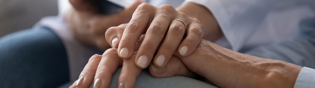 Young woman doctor nurse wear white medical uniform holding hand of senior old female grandmother patient having disease health problem give support help empathy and comfort concept, close up view