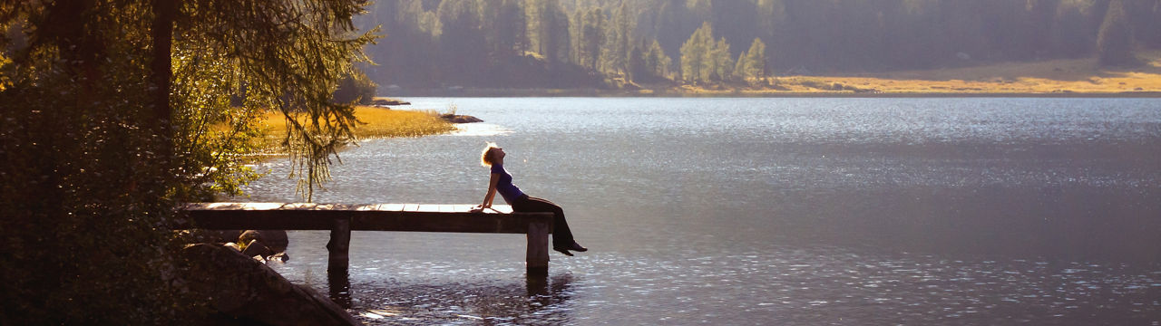 Young woman enjoying the nature on the mountain lake