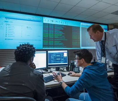 Business people talking in server room