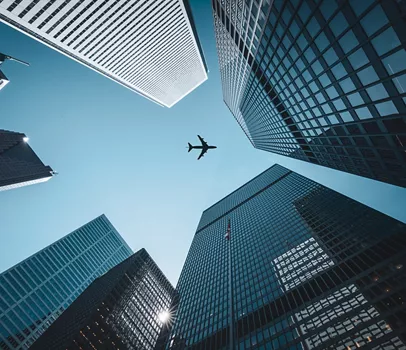 Digital generated image of commercial airplane flying over skyscrapers