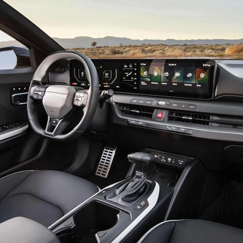 Interior of the 2026 Kia K4 sedan, including steering wheel and nearly 30 inches of digital instrumentation