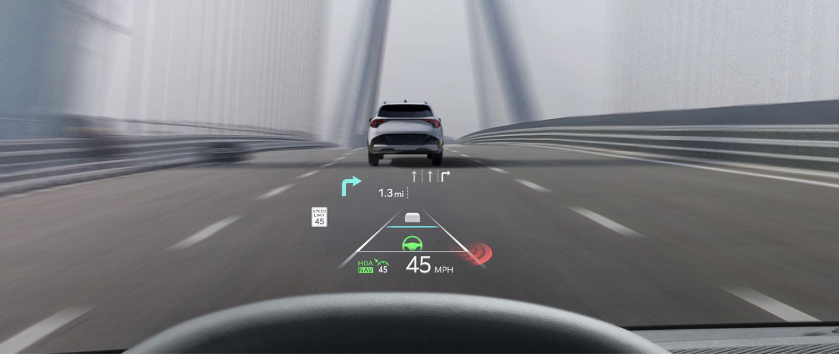 Interior of the 2027 Kia Sorento Hybrid from the driver’s perspective, featuring a clear head-up display with key driving info like the speed limit, mph, and directions. The view out of the windshield is of a road on a bridge with a white vehicle in front.