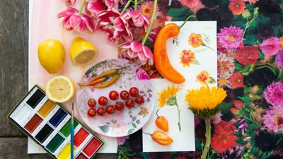 A plate with watercolors and fruit
