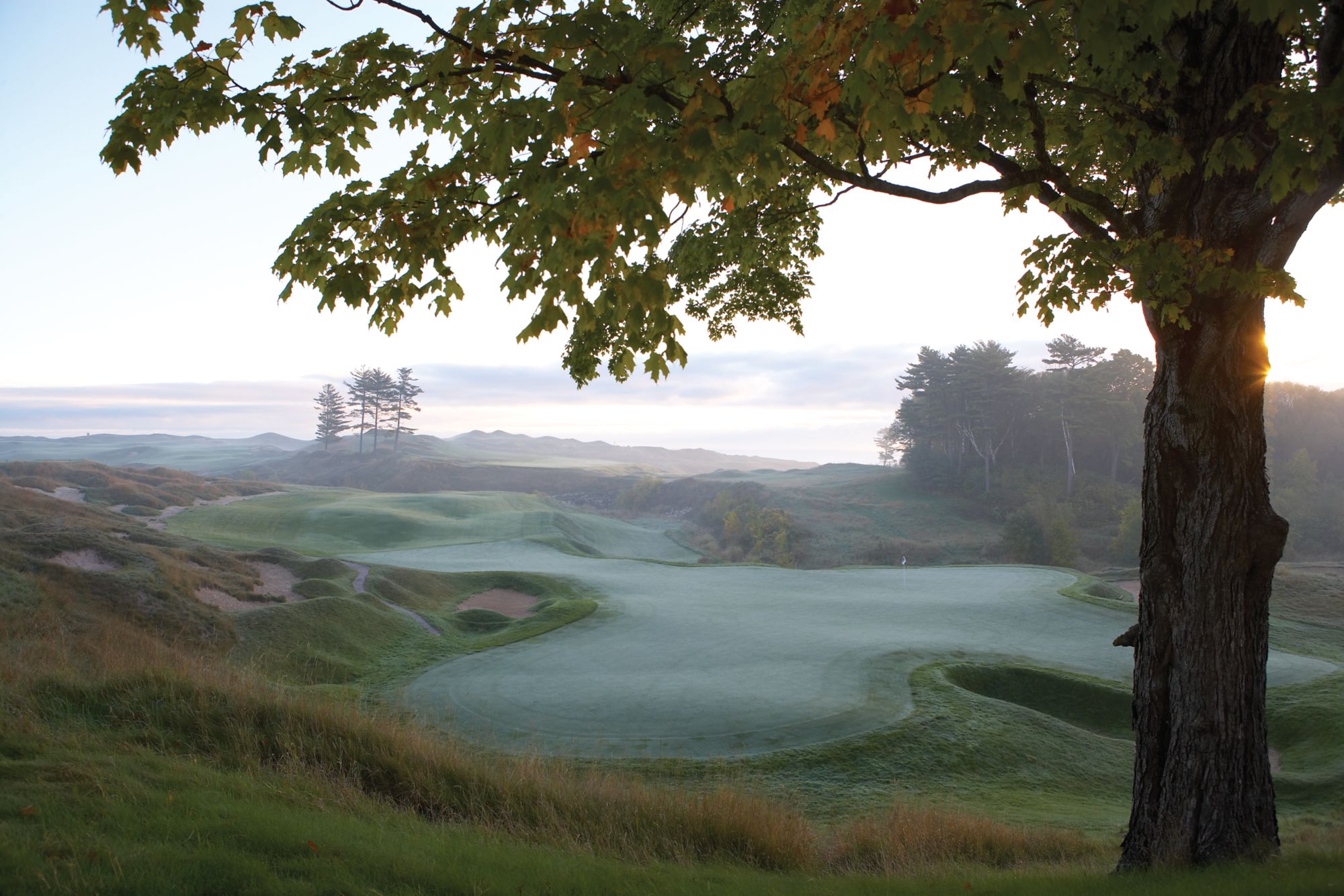 the 18th golf hole green of The Straits course covered in dew