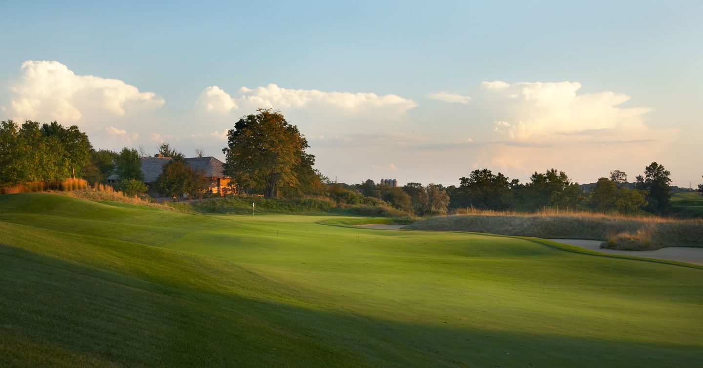 The fairway of hole 3 on the River Course with the green and clubhouse in the background. 