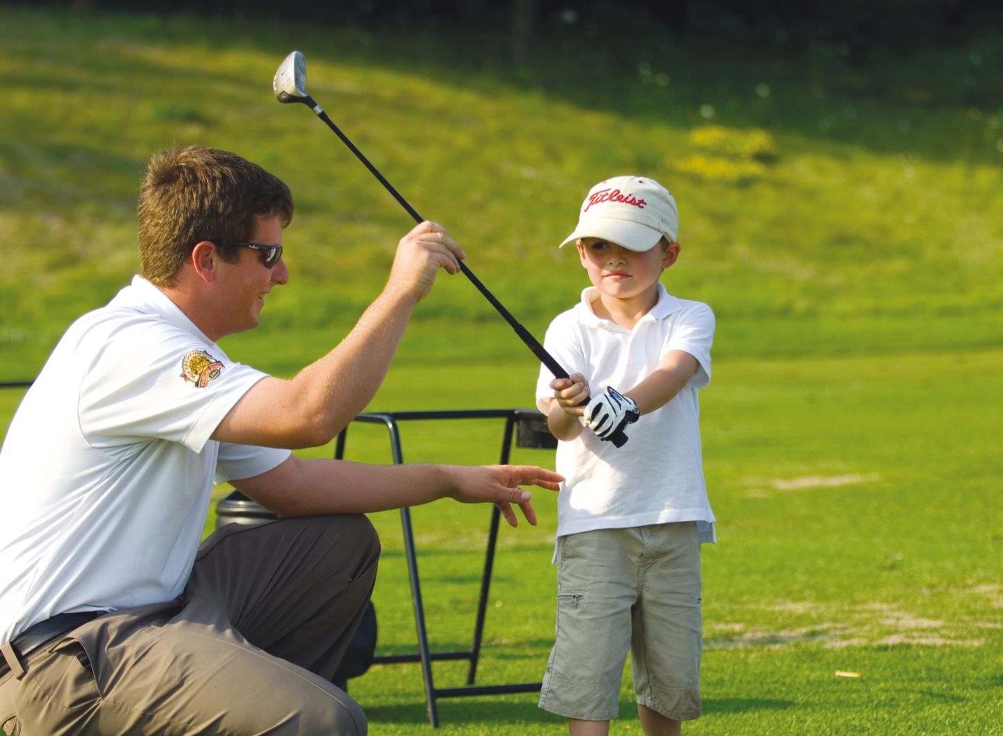 junior golfer receiving golf swing instruction