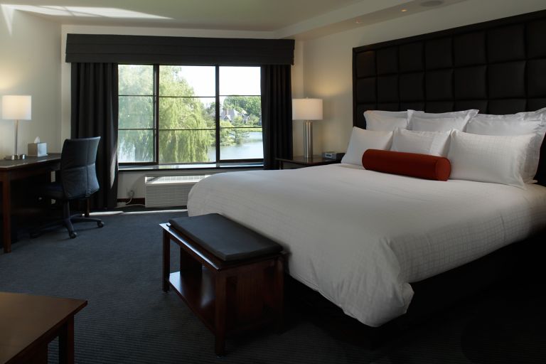 a king bed in a Lakeside Room at Inn on Woodlake