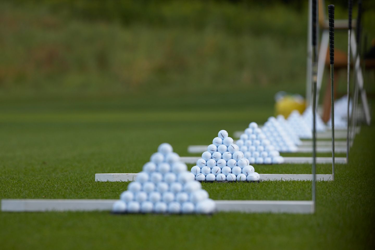 golf balls stacked on a golf range