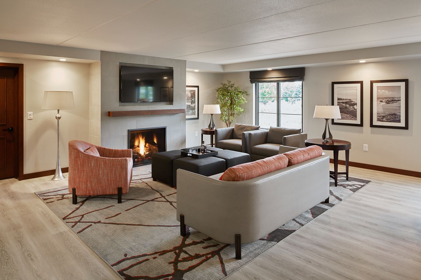 A view of the fireplace and seating area surrounding it in The Horizon Suite at The Inn on Woodlake