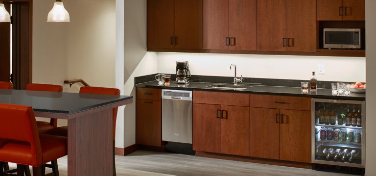Cabinets, sink and mini fridge inside The Horizon Suite in The Inn on Woodlake