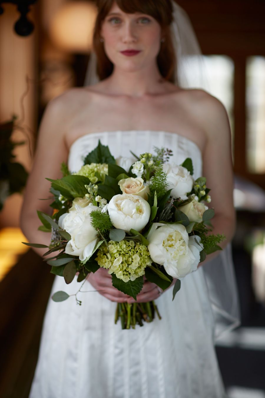a beautiful bride in a white wedding dress holding a flowers