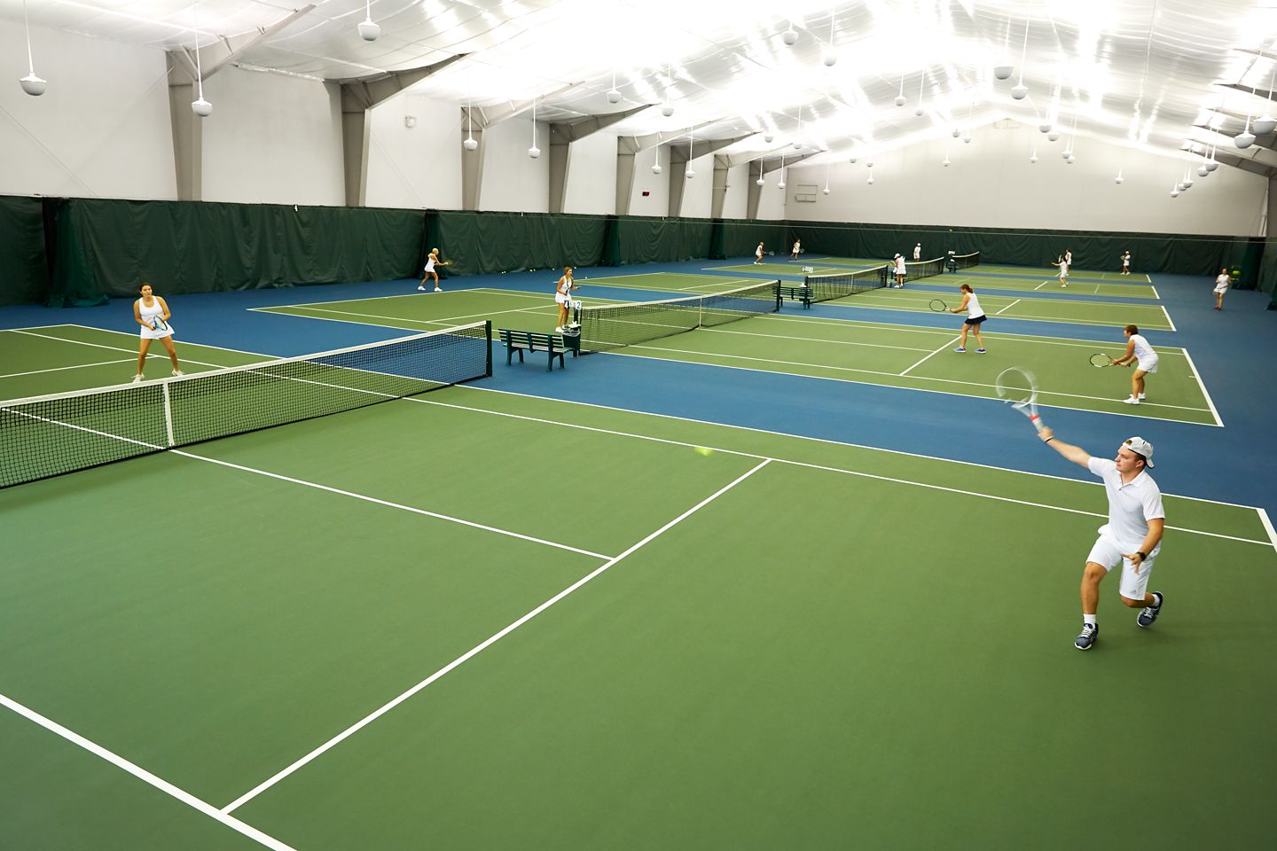 Tennis players playing on indoor courts